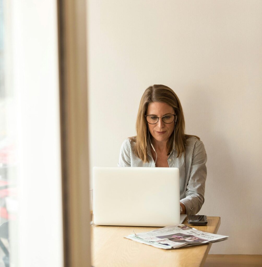 Woman Sitting While Using Laptop