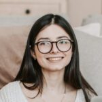 Cheerful woman using laptop at home